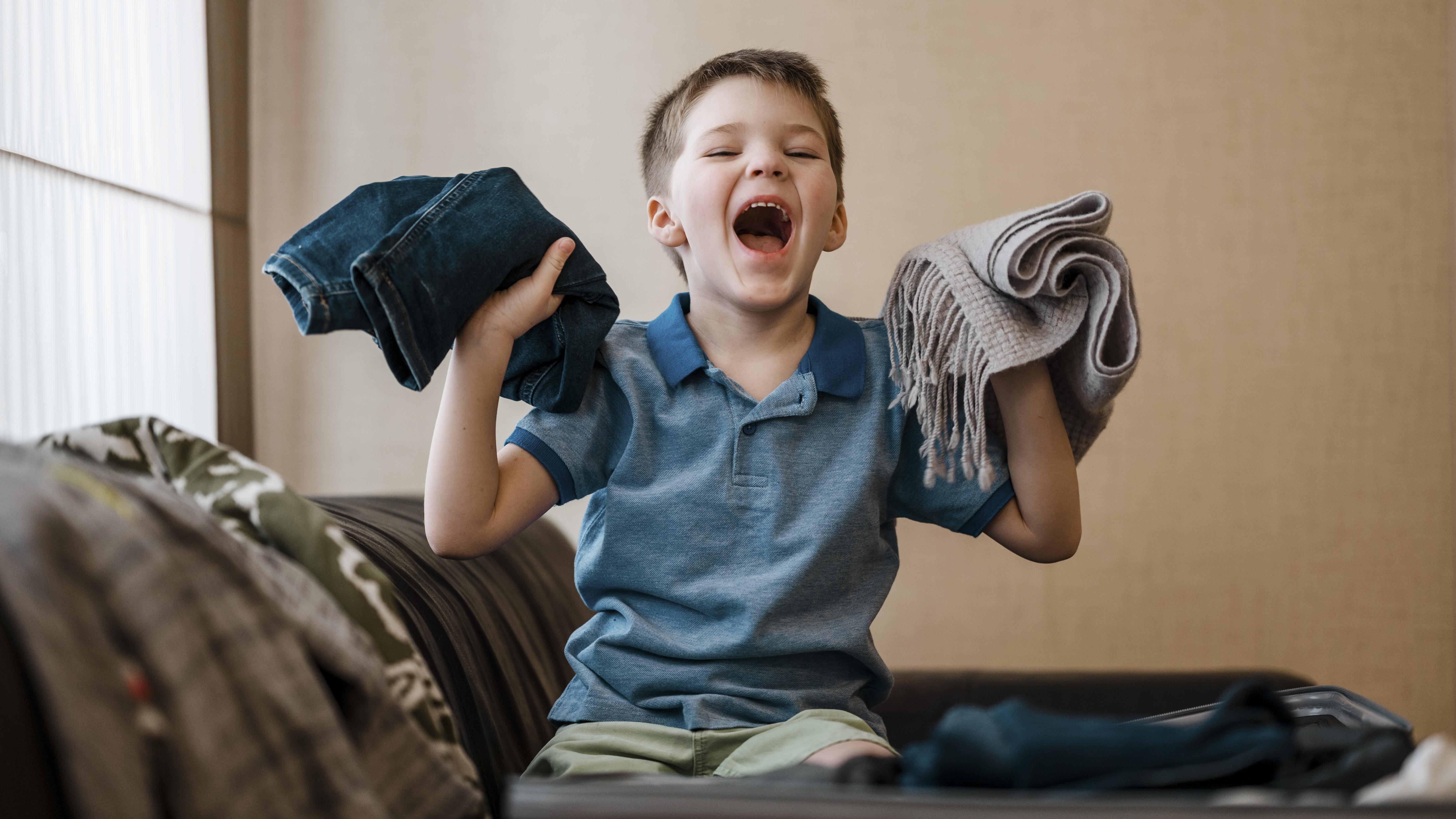 child holding clothes
